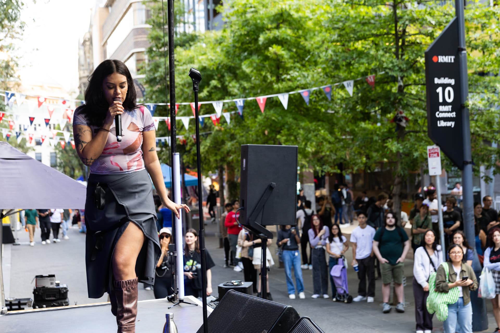 Performer on stage at an RMIT University outdoor event