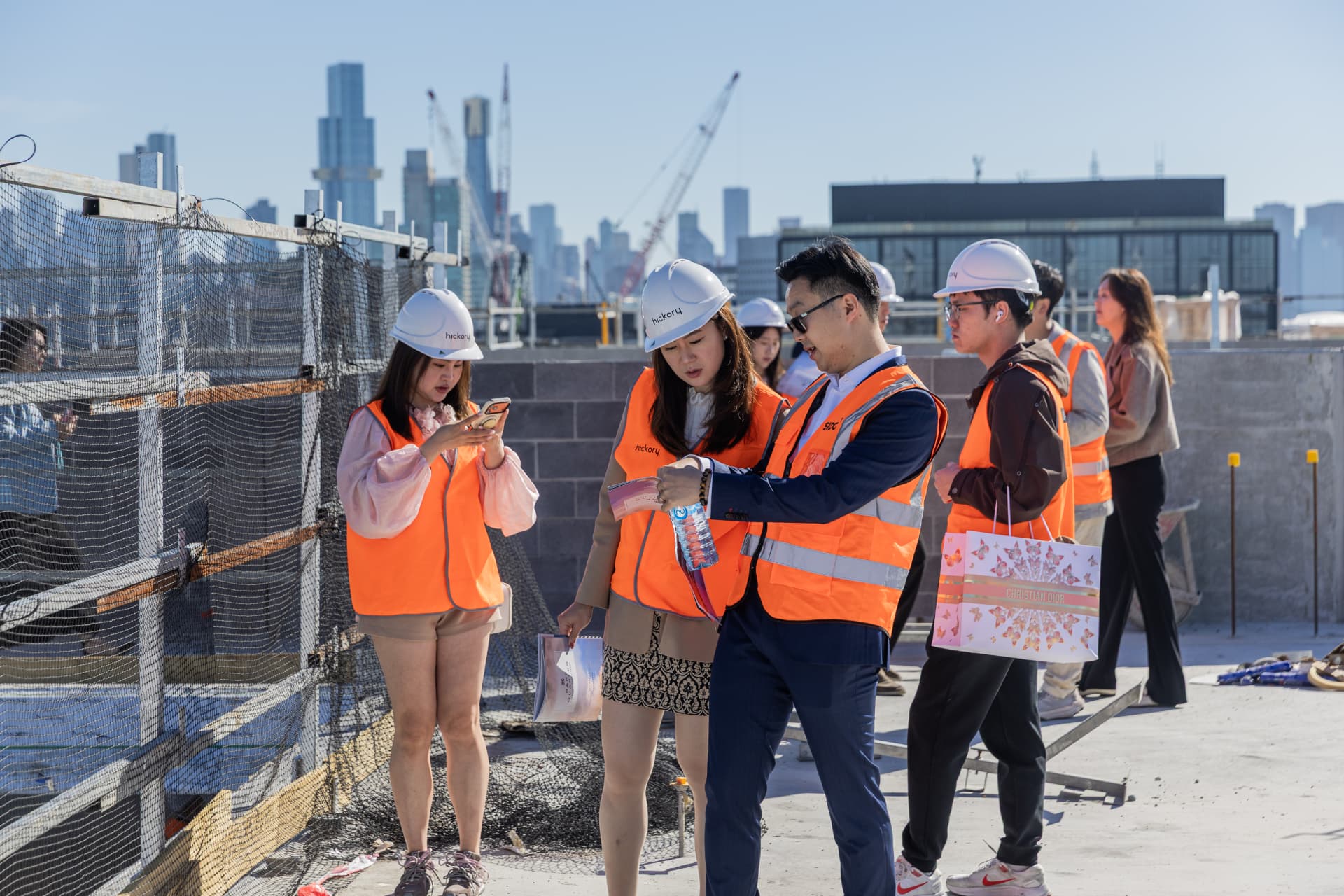 Guests in hi-vis on the Park Quarter rooftop with the Melbourne skyline
