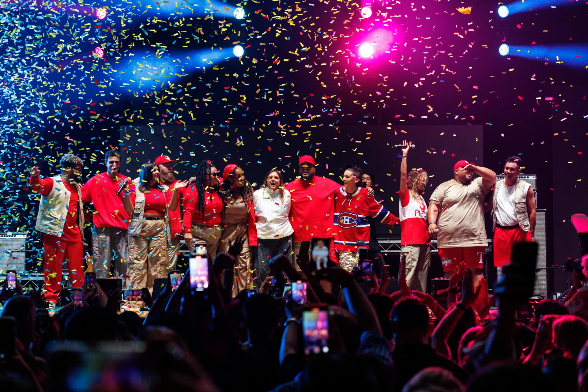 Performers on stage celebrating under confetti at a Chemist Warehouse event