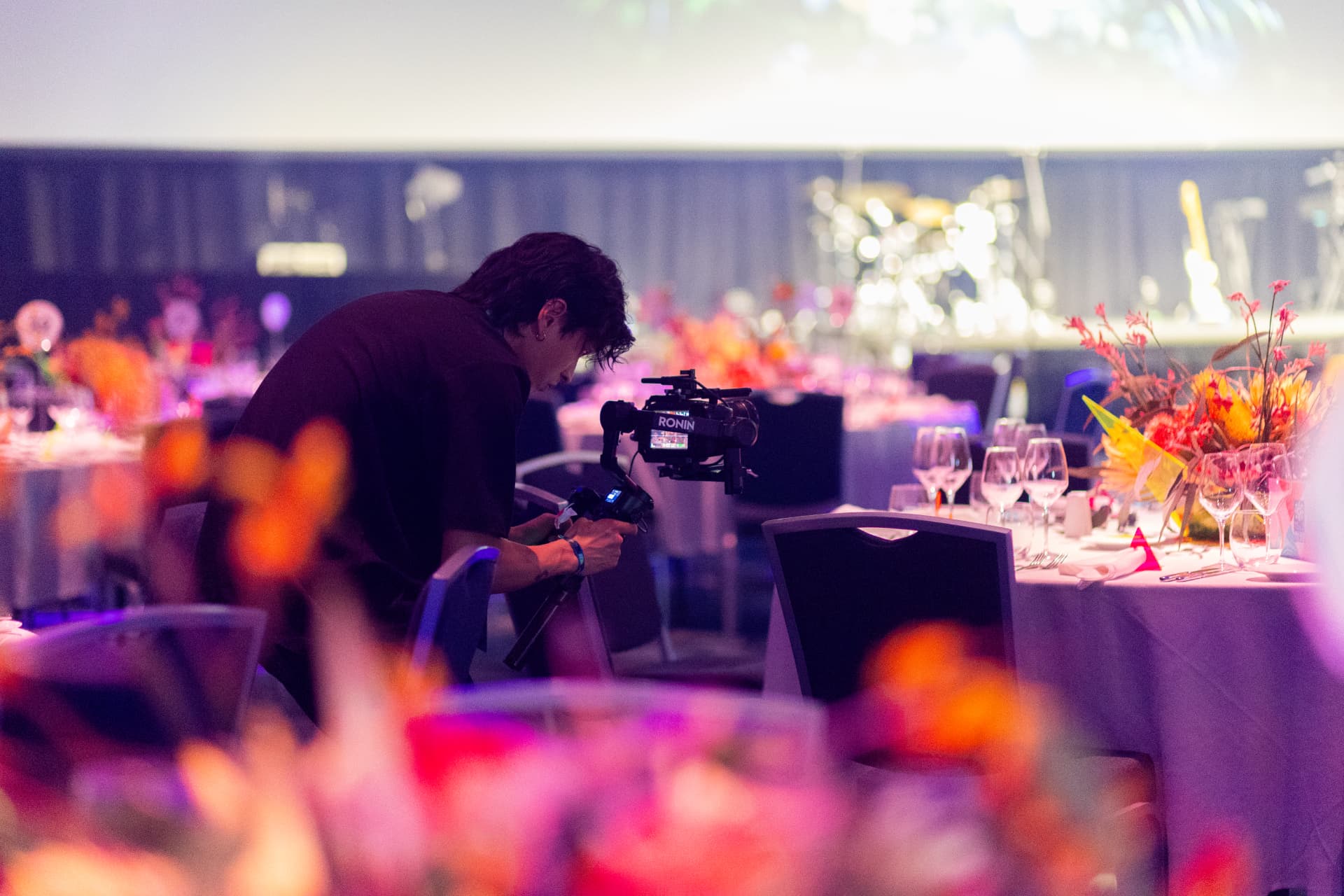 Camera operator filming a gala dinner for the FIFA Women's World Cup